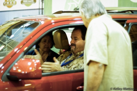 Denny Schenck, owner of Car Craft Inc., is shown with one of the  6 recipients at the Car Charity Luncheon..  Denny's company, Car Craft Inc.,.  refurbished 2 of the cars.